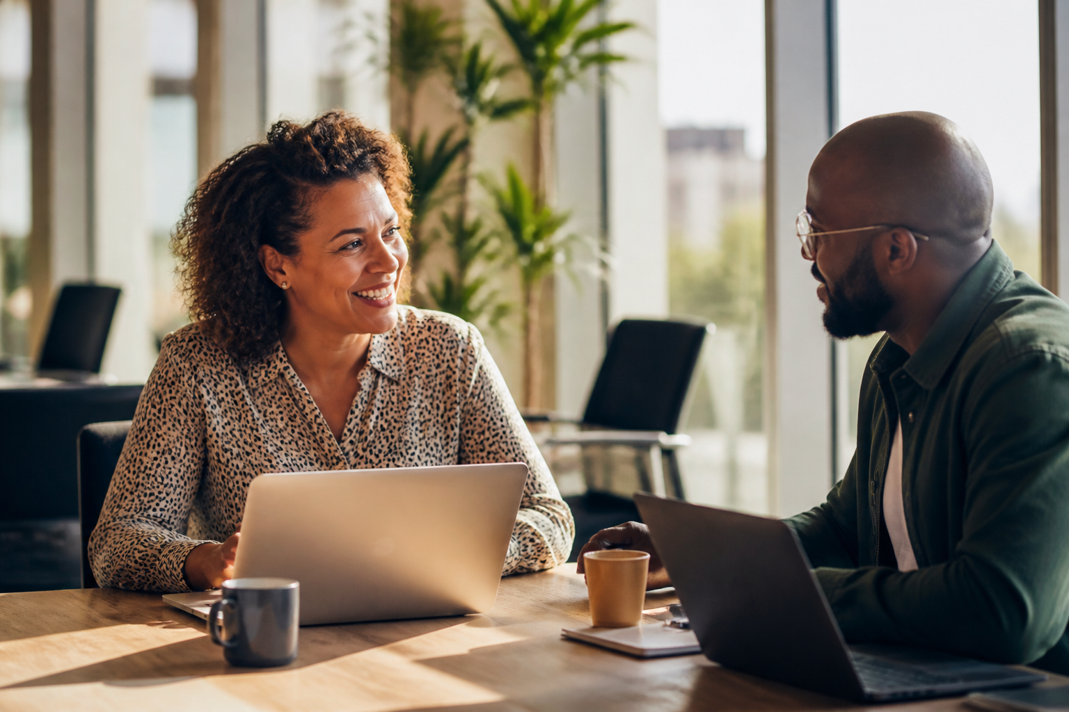 HR manager discussing sustainable workplace benefits with a colleague in a bright office.