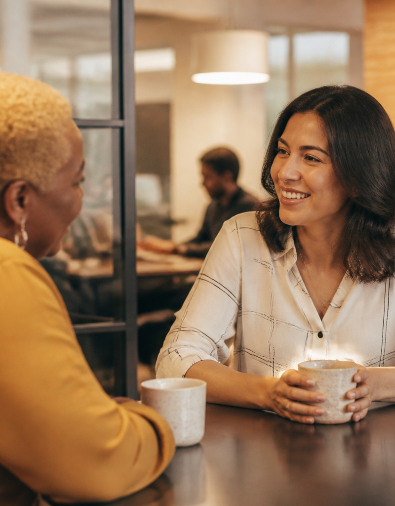 An HR lead discussing workplace options with an employee in a modern UK office
